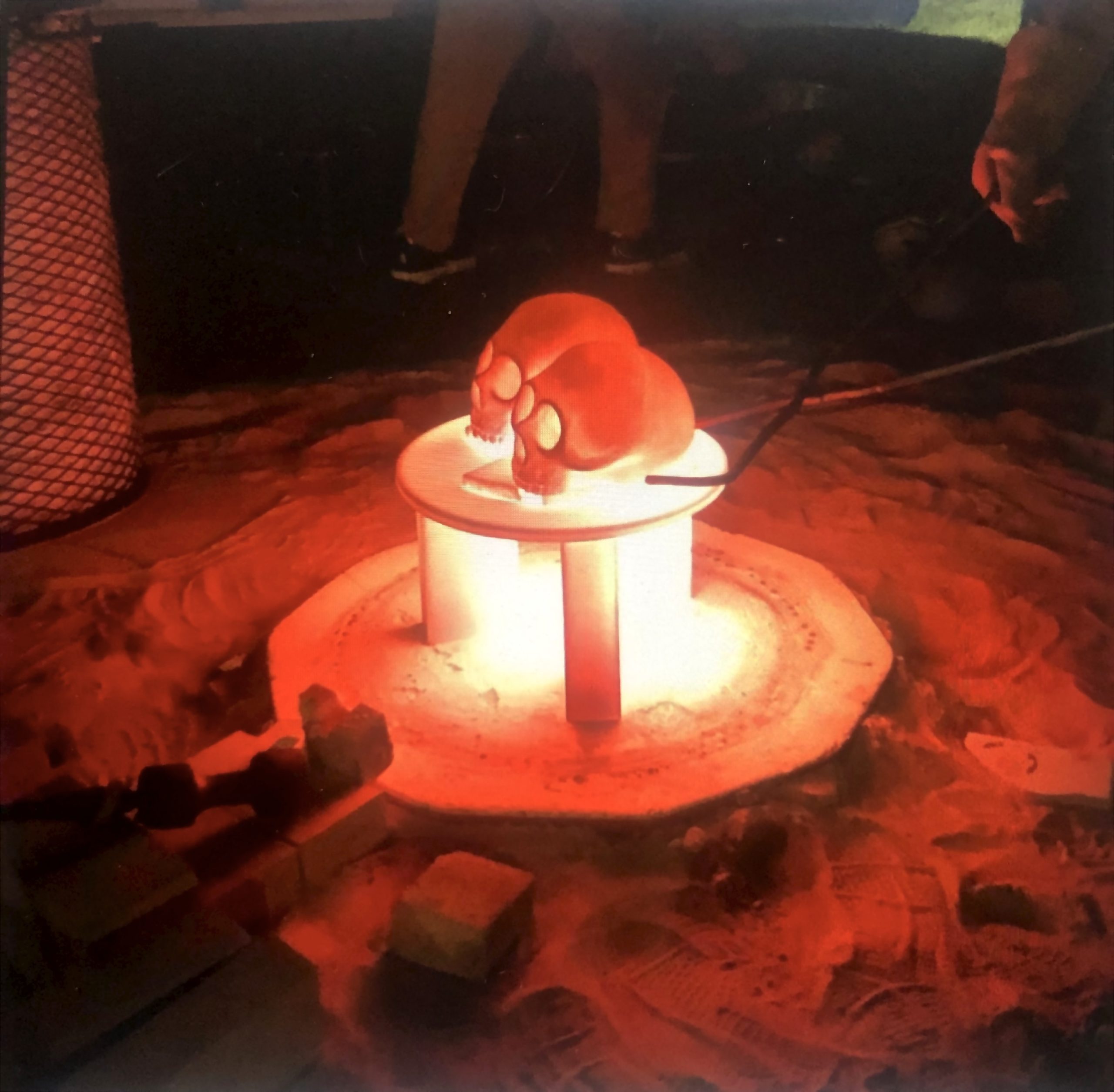 Two glowing red hot skulls inside a raku kiln