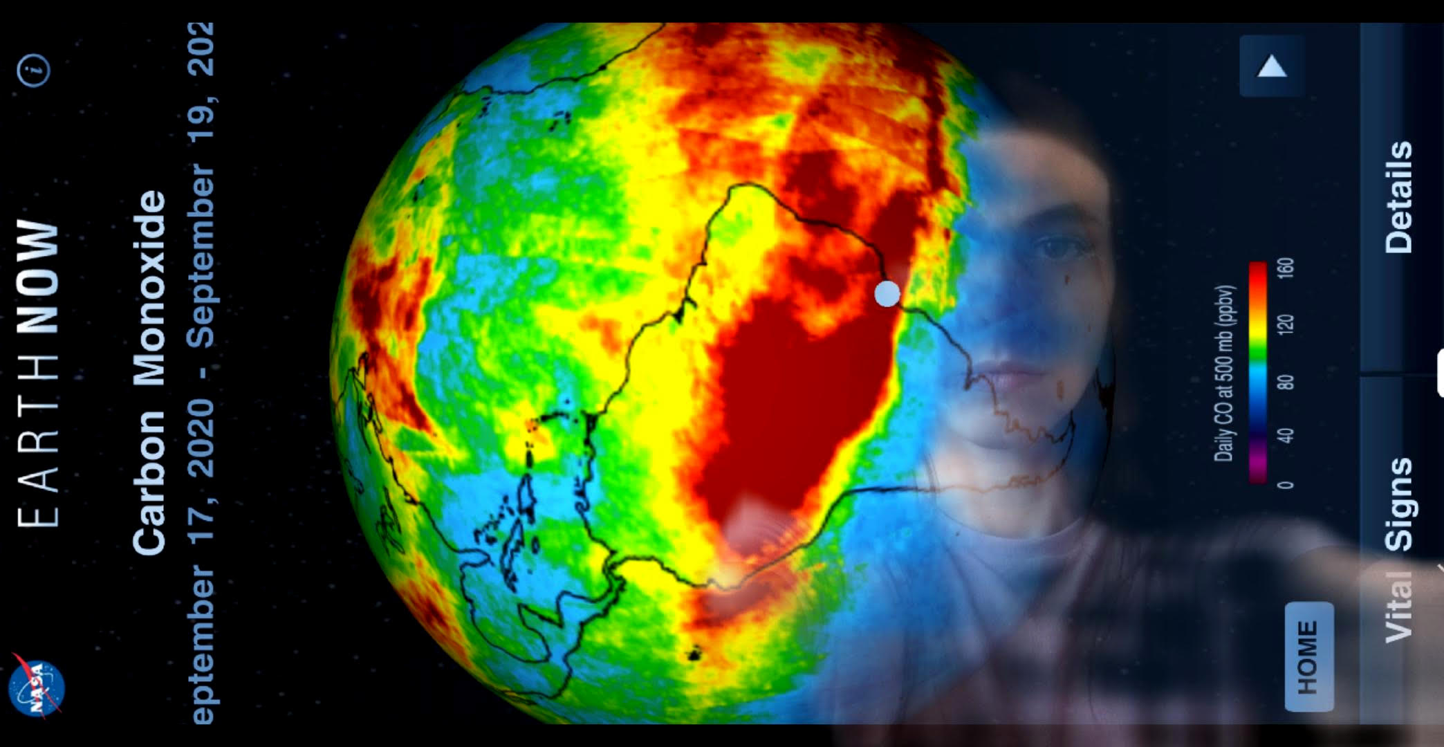 the image of a phone screen with a thermal map of the world superimposed over a person's face