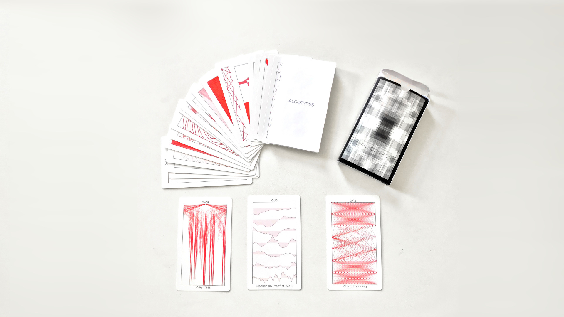 a deck of cards with black and red images on them splayed on a white background